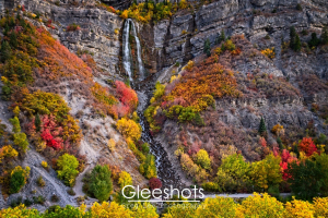 Bridal Veil Falls can be seen in its autumn splendor, showcasing vibrant fall colors of red, orange, yellow, and green.   Utah Landscape Photography Print for Sale.  