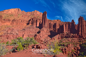 The red and orange rock spires of the Fisher Towers in Moab dominate the background of this scene, with a lone yellow bush showing its autumn colors in the foreground.  Utah Fine Art Landscape Photography Print for Sale.