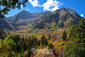 Mt Timpanogos adorned in fall colors of green, yellow, red, and pink under a bright blue sky.  Utah Fine Art Landscape Photography Print for Sale.